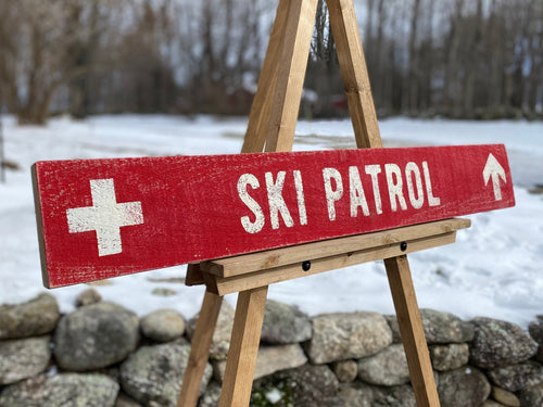 Large Ski Patrol Sign on Rustic Barnboard